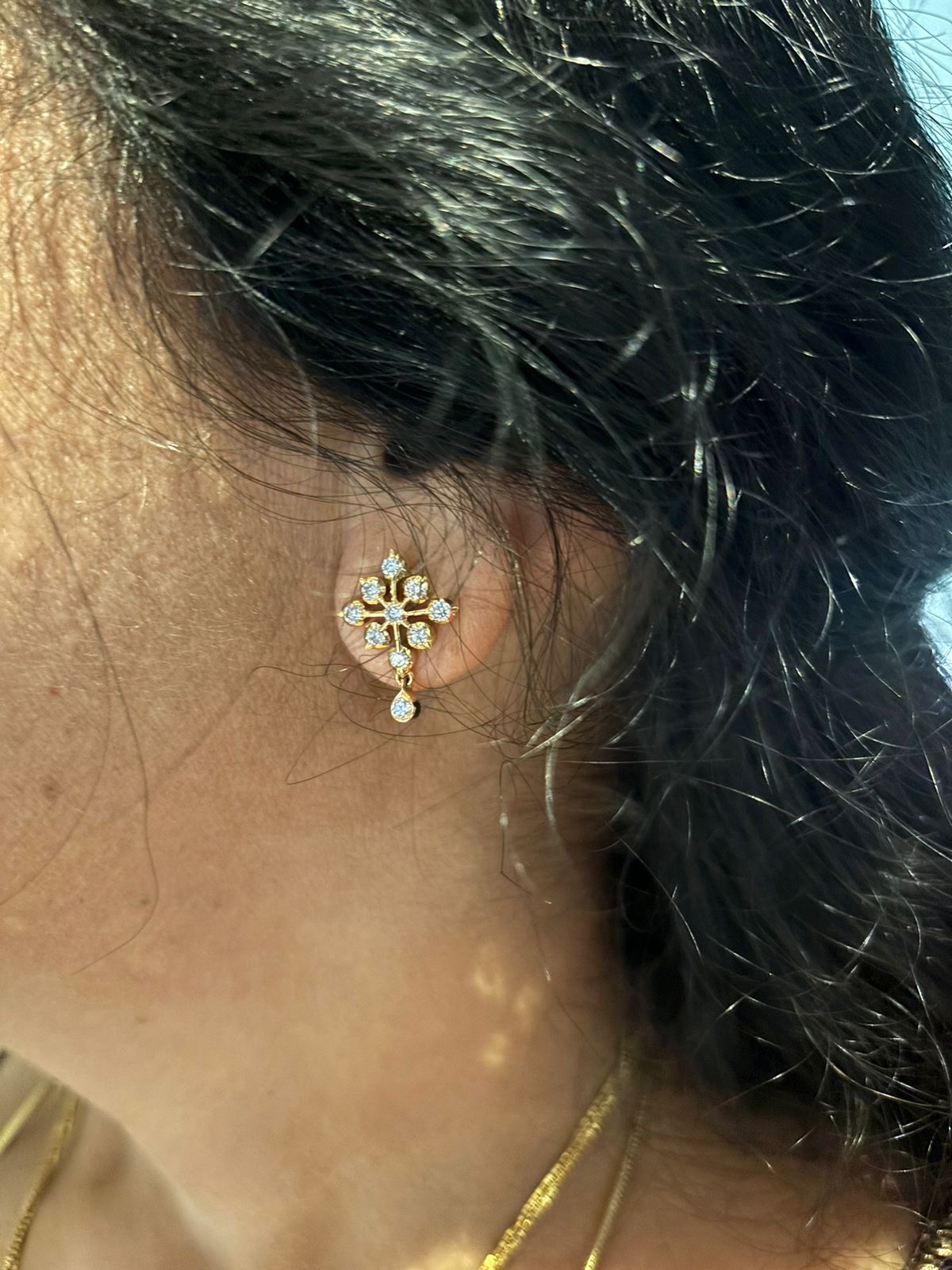 A customer wearing her finished diamond earring